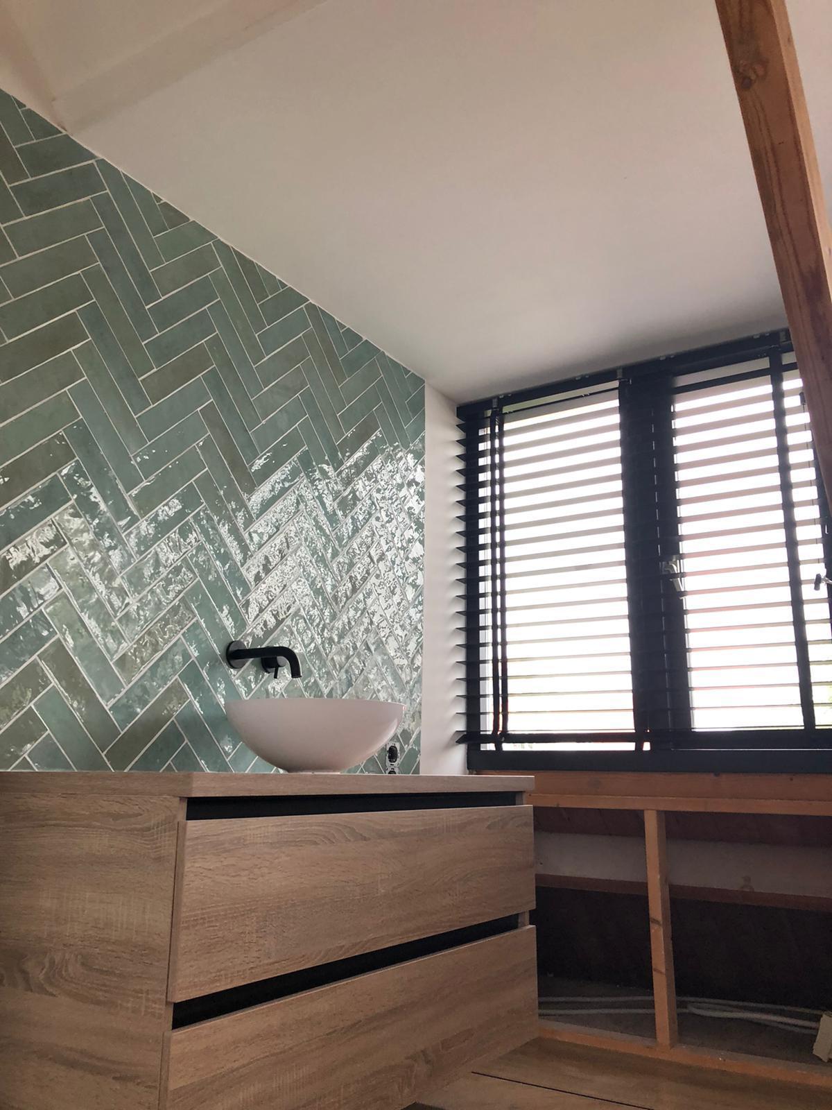 Badkamer met groen visgraat tegelwerk
